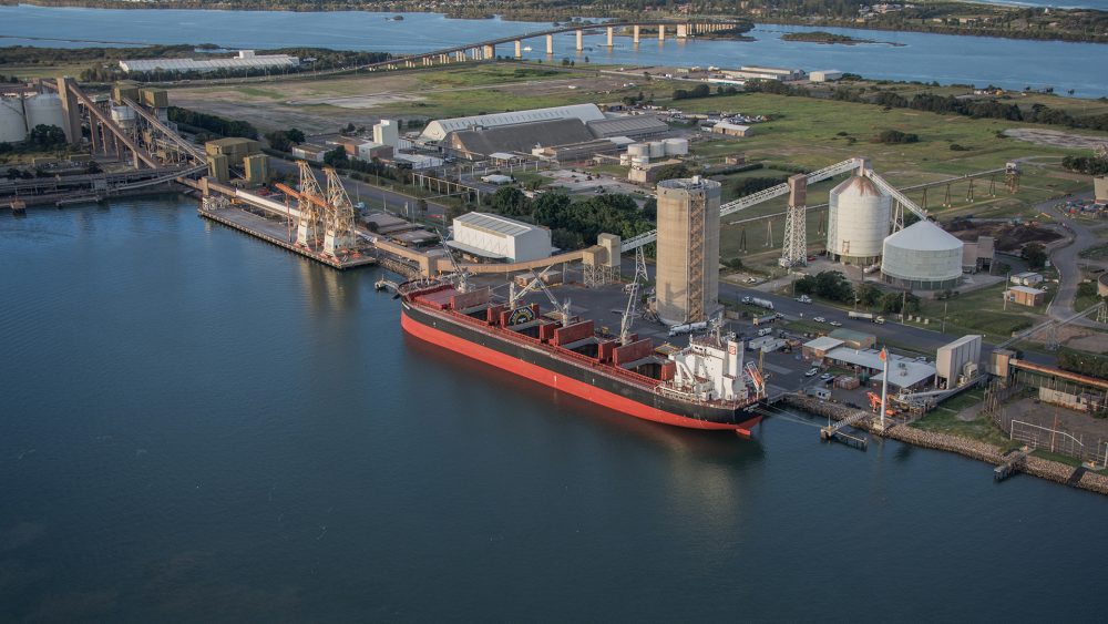 An aerial view of Port of Newcastle, including a large ship docking at the habour