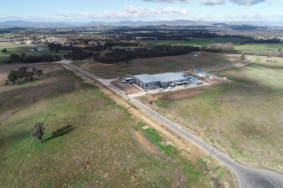 Aerial shot of Circular Plastics factory in the middle of green-grassed land